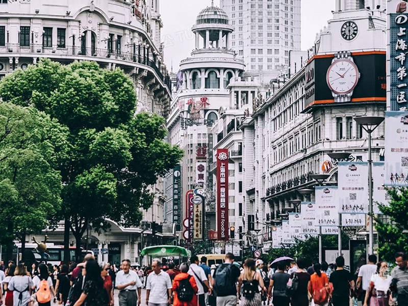 Crowded Nanjing Road Pedestrian Street with historic buildings and shoppers.