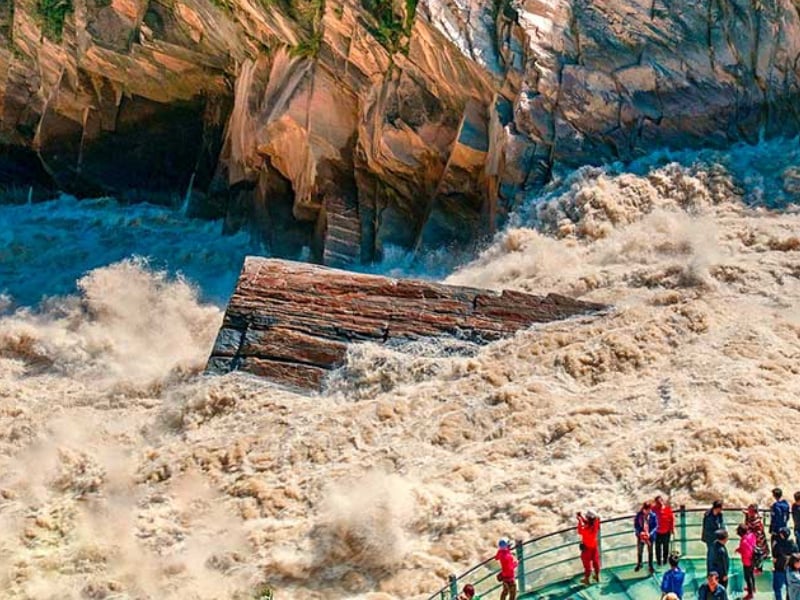 Upper Tiger Leaping Gorge where the Jinsha River roars through a narrow canyon, a highlight of classic Yunnan tours from Shangri-La to Lijiang.