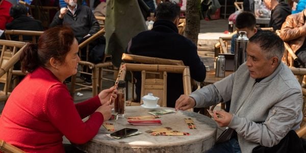 Local residents drinking tea and playing cards at People’s Park teahouse in Chengdu, experiencing the city’s slow lifestyle