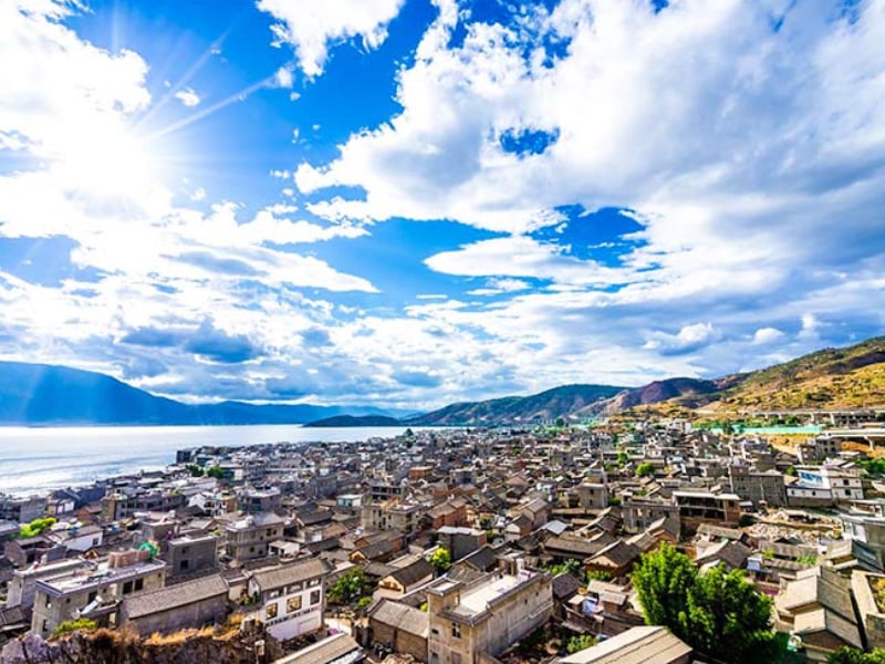 Panoramic view of Dali Old Town with Bai architecture, Erhai Lake, and Cangshan Mountains in Yunnan